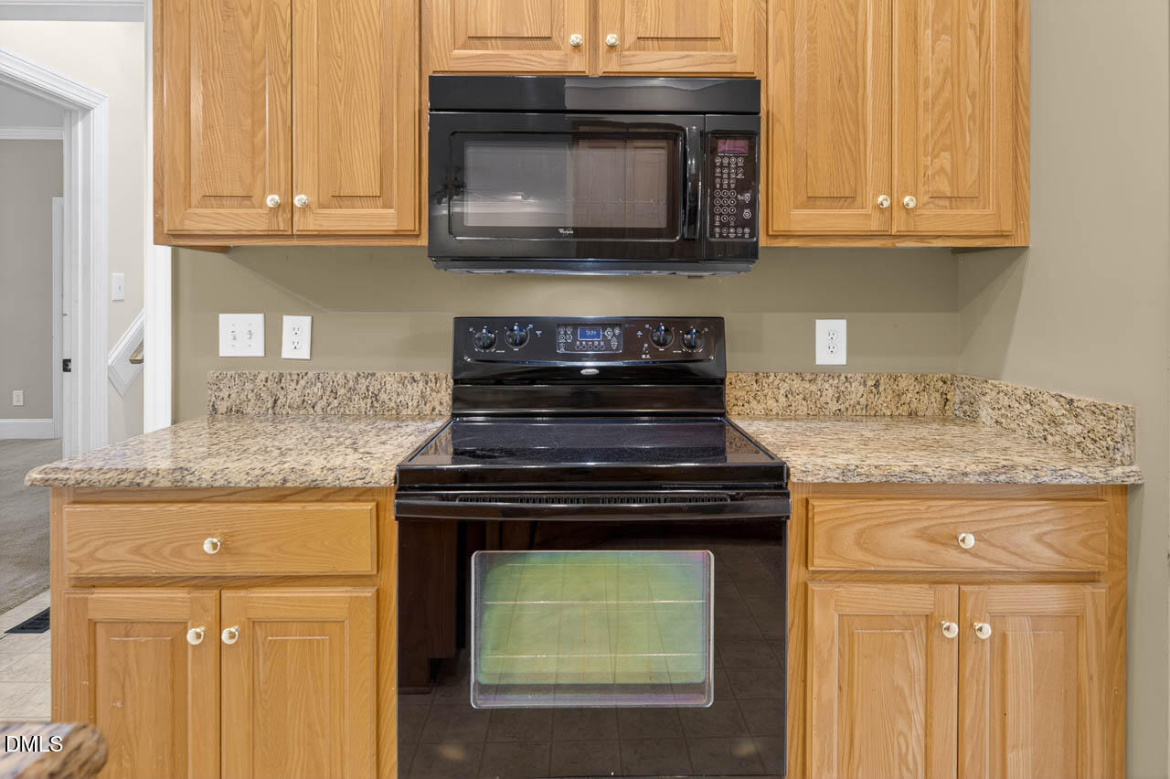 2209 Lodestar Drive Raleigh, NC 27615 - Photo 6 of 50 a stove top oven sitting inside of a kitchen