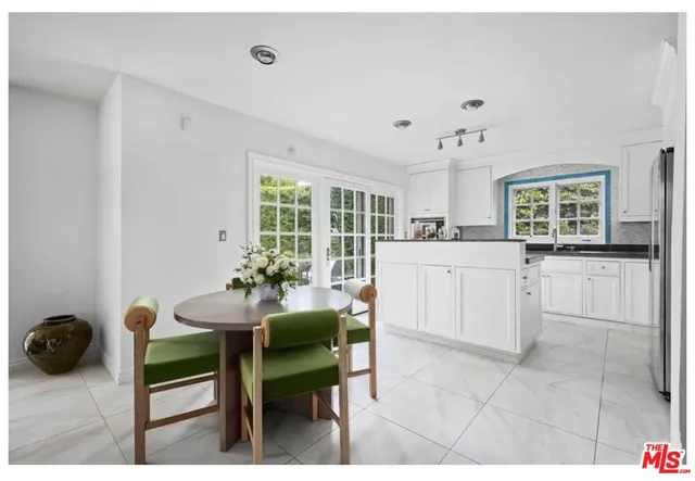 a kitchen with a table chairs and a refrigerator