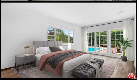 a bedroom with a bed and glass window