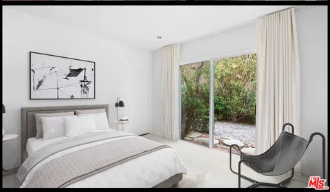 a bedroom with a bed and glass window