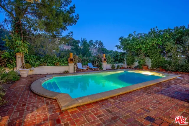 a view of a swimming pool with a patio