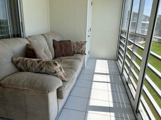 a living room with a couch and a rug