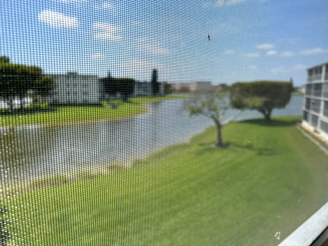 a view of a swimming pool with seating area and covered with water fall