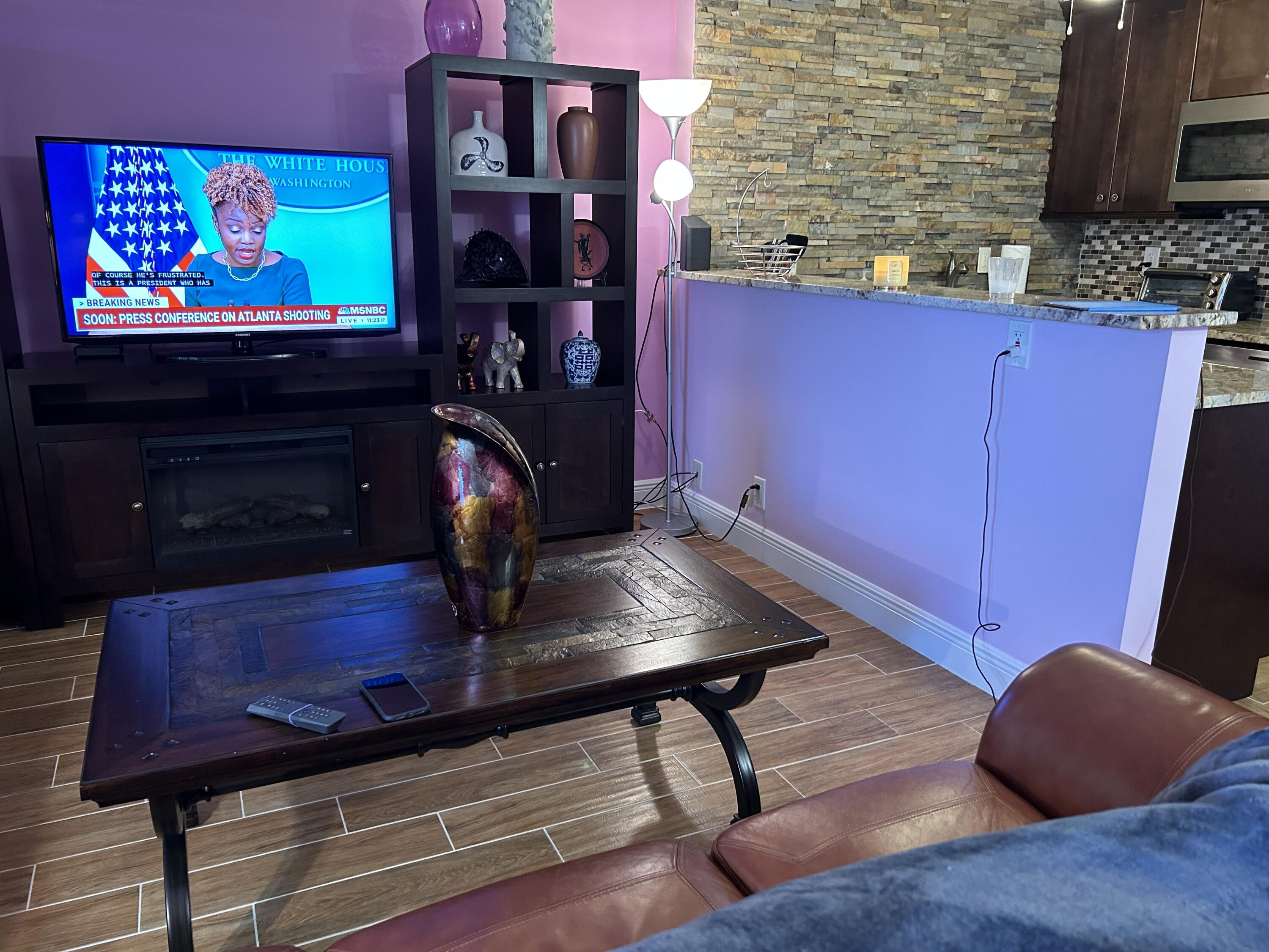 3070 Cornwall East, Unit 3070D Boca Raton, FL 33434 - Photo 17 of 22 a room with wooden floor and a fireplace