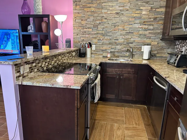 a kitchen with a sink stove and cabinets