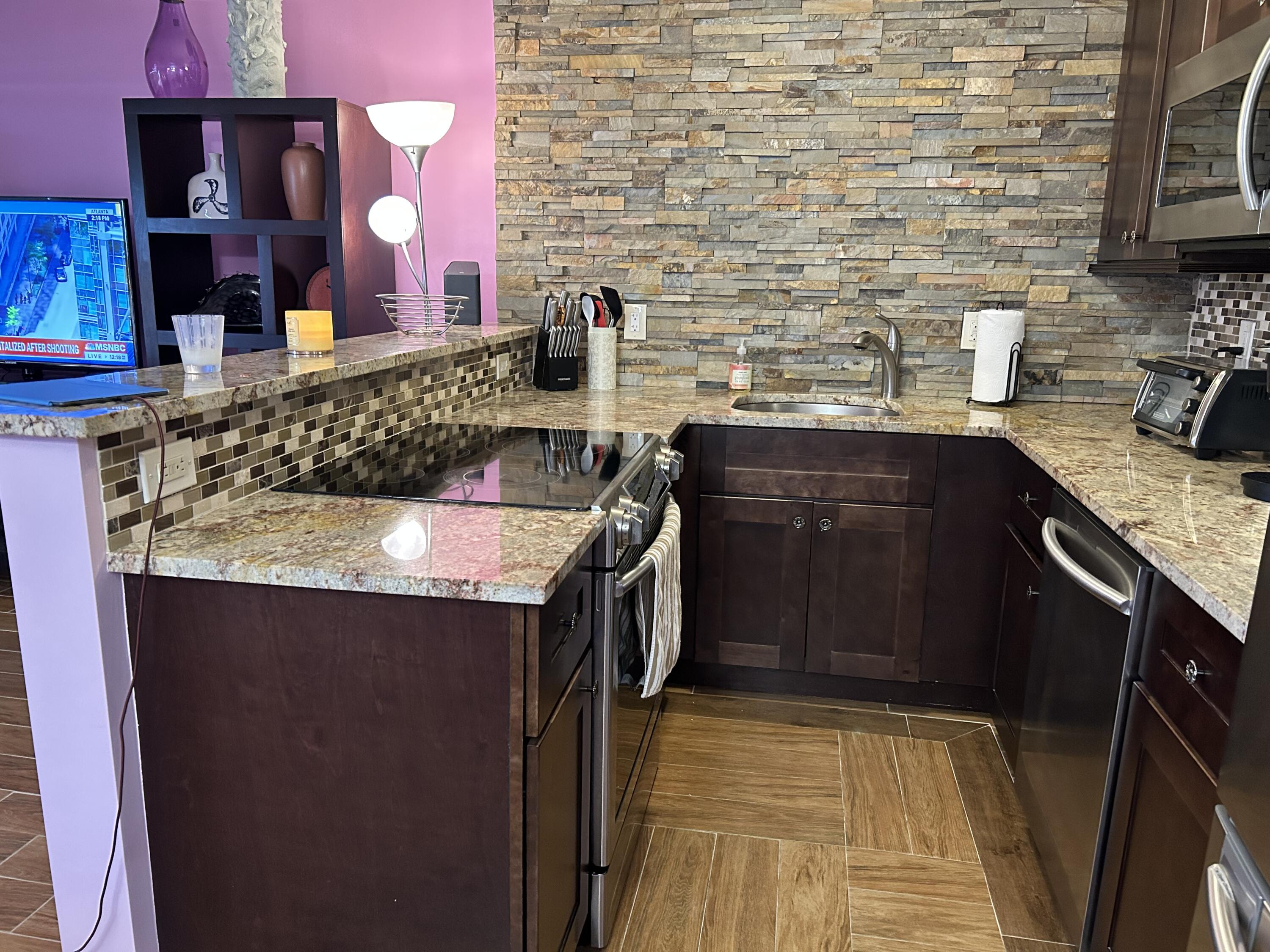 3070 Cornwall East, Unit 3070D Boca Raton, FL 33434 - Photo 2 of 22 a kitchen with a sink stove and cabinets
