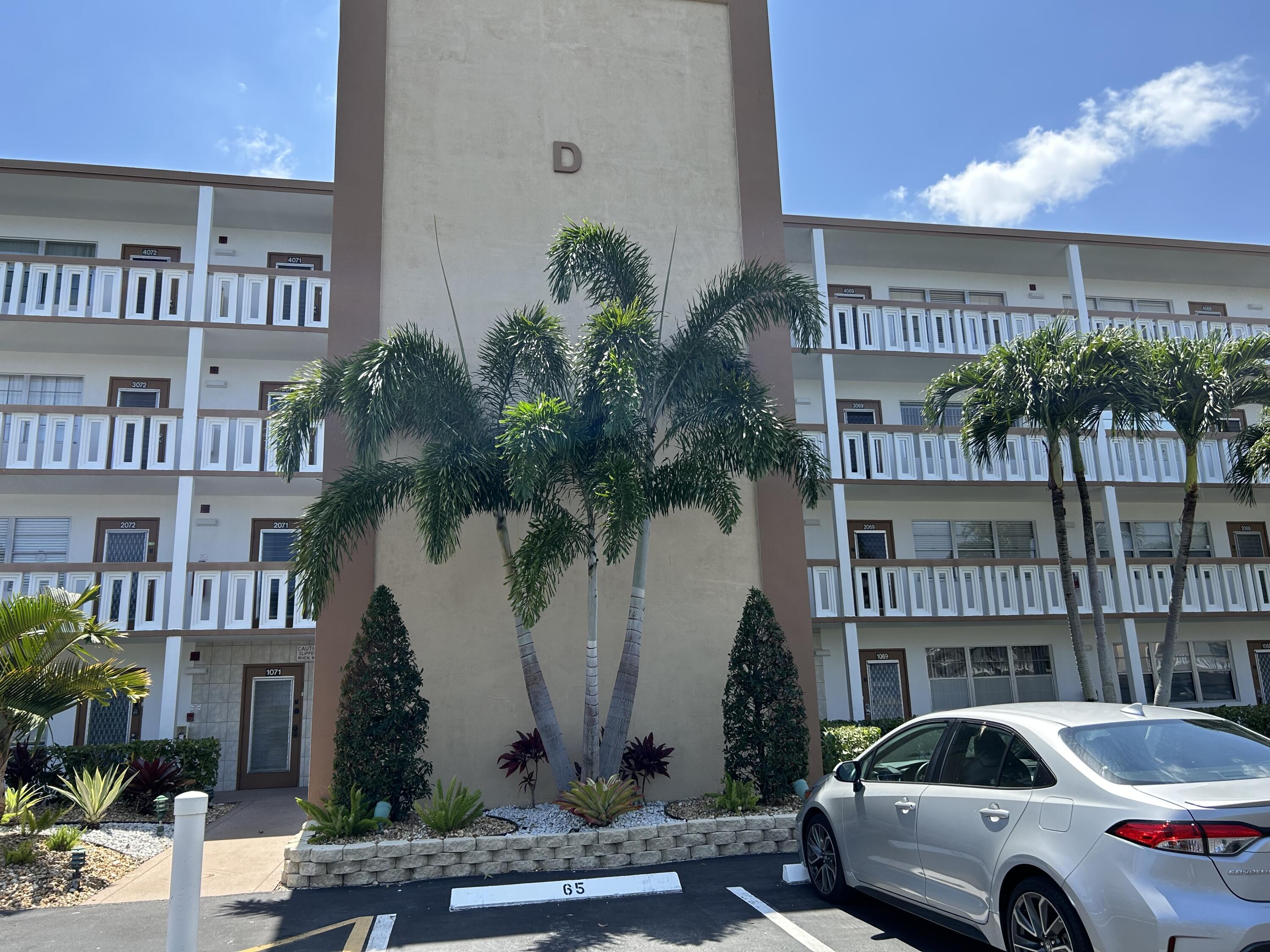 3070 Cornwall East, Unit 3070D Boca Raton, FL 33434 - Photo 22 of 22 a car parked in front of a building