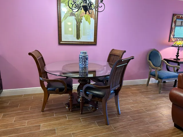 a view of a dining room with furniture and wooden floor