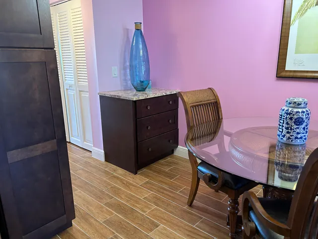 a view of a room with furniture and wooden floor