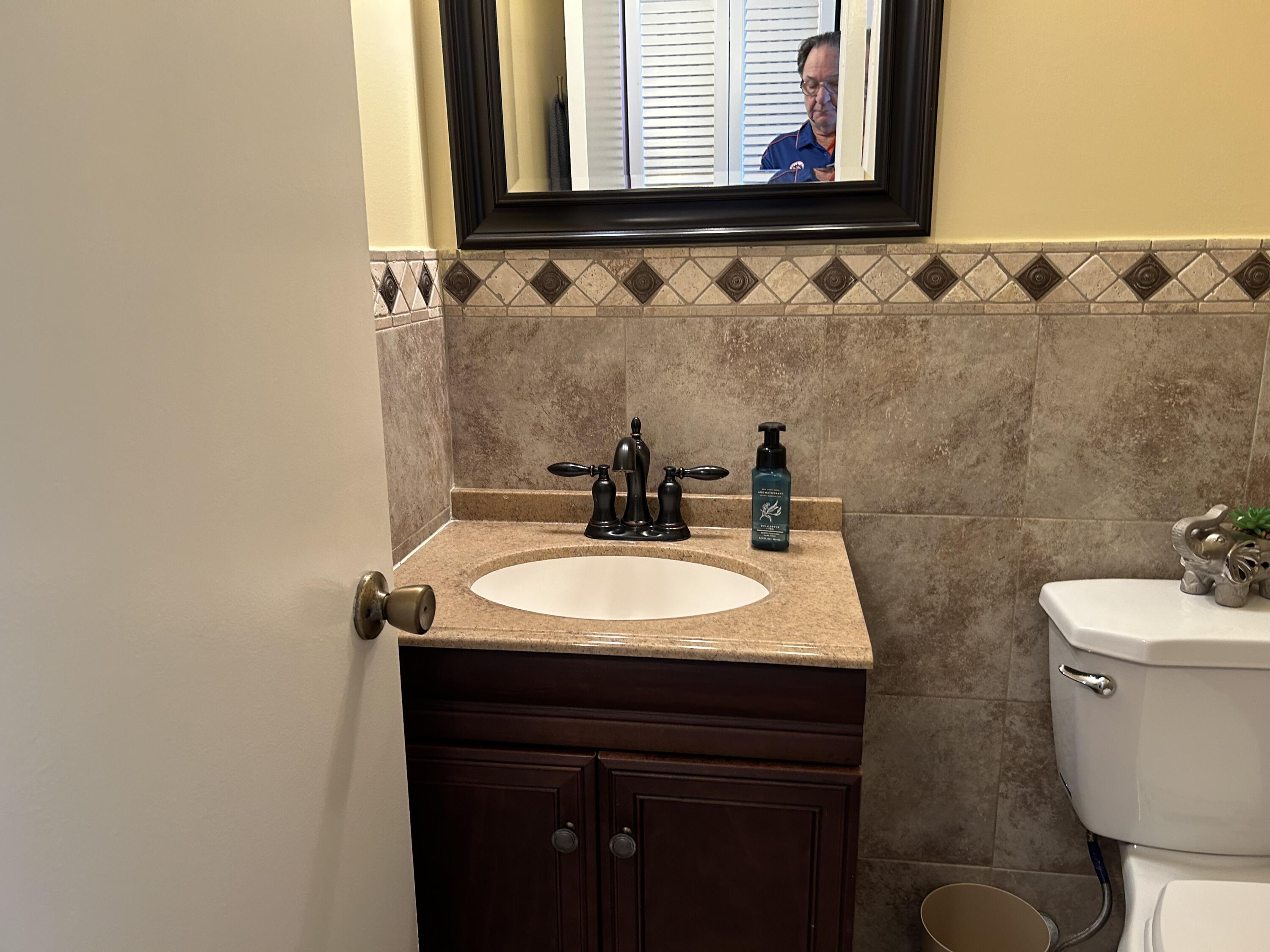 3070 Cornwall East, Unit 3070D Boca Raton, FL 33434 - Photo 7 of 22 a bathroom with a sink and a mirror