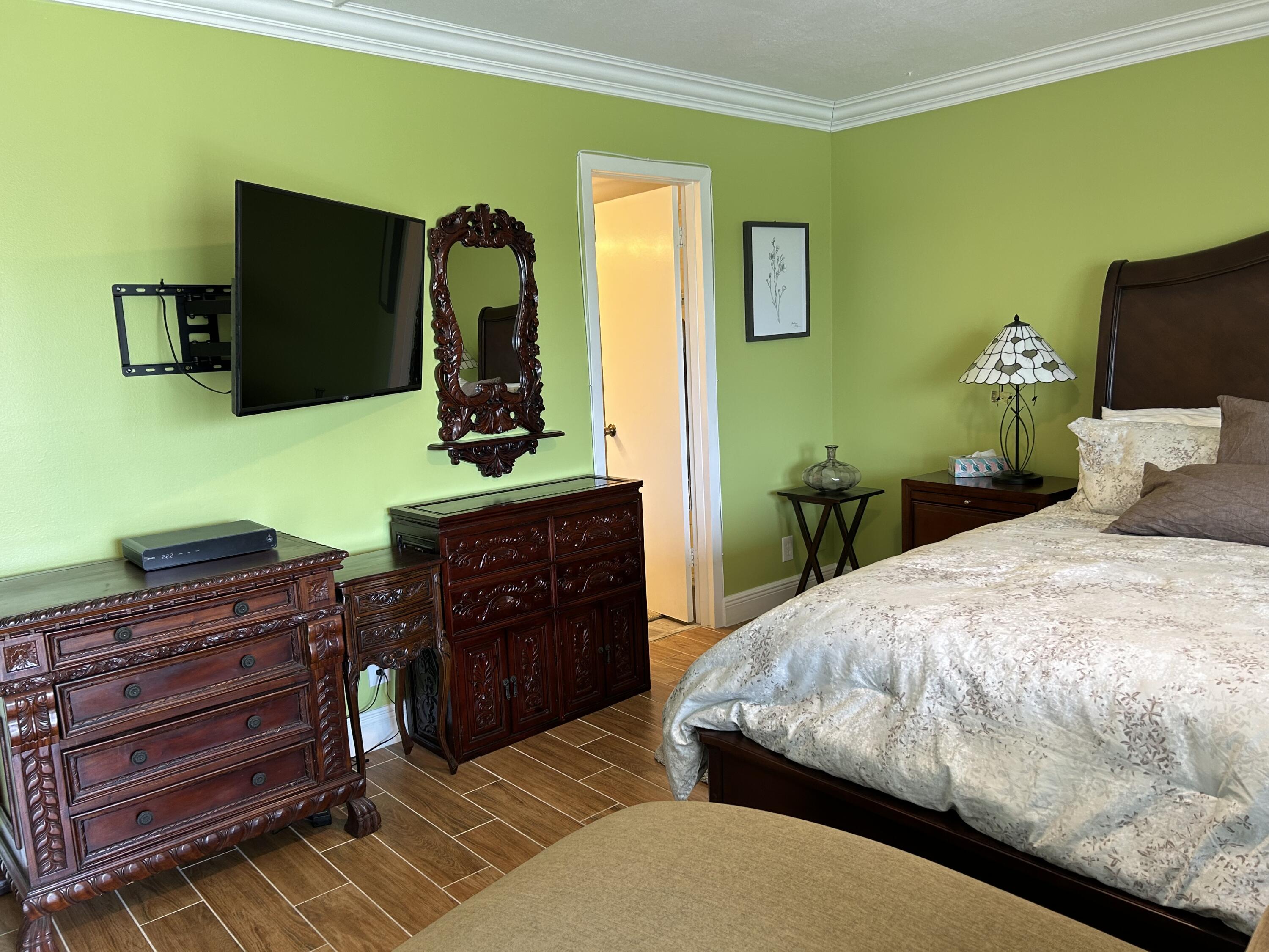 3070 Cornwall East, Unit 3070D Boca Raton, FL 33434 - Photo 9 of 22 a bedroom with a bed and furniture