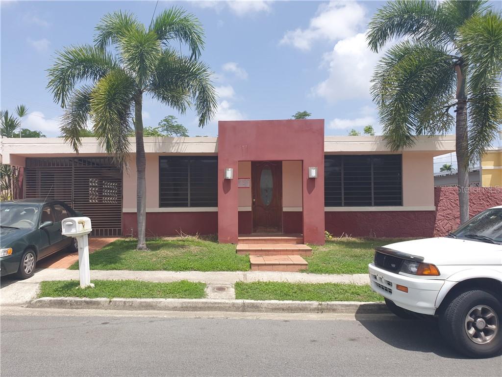 17 8th Guaynabo, PR 00966 - Photo 1 of 1 a car parked in front of a house with a yard