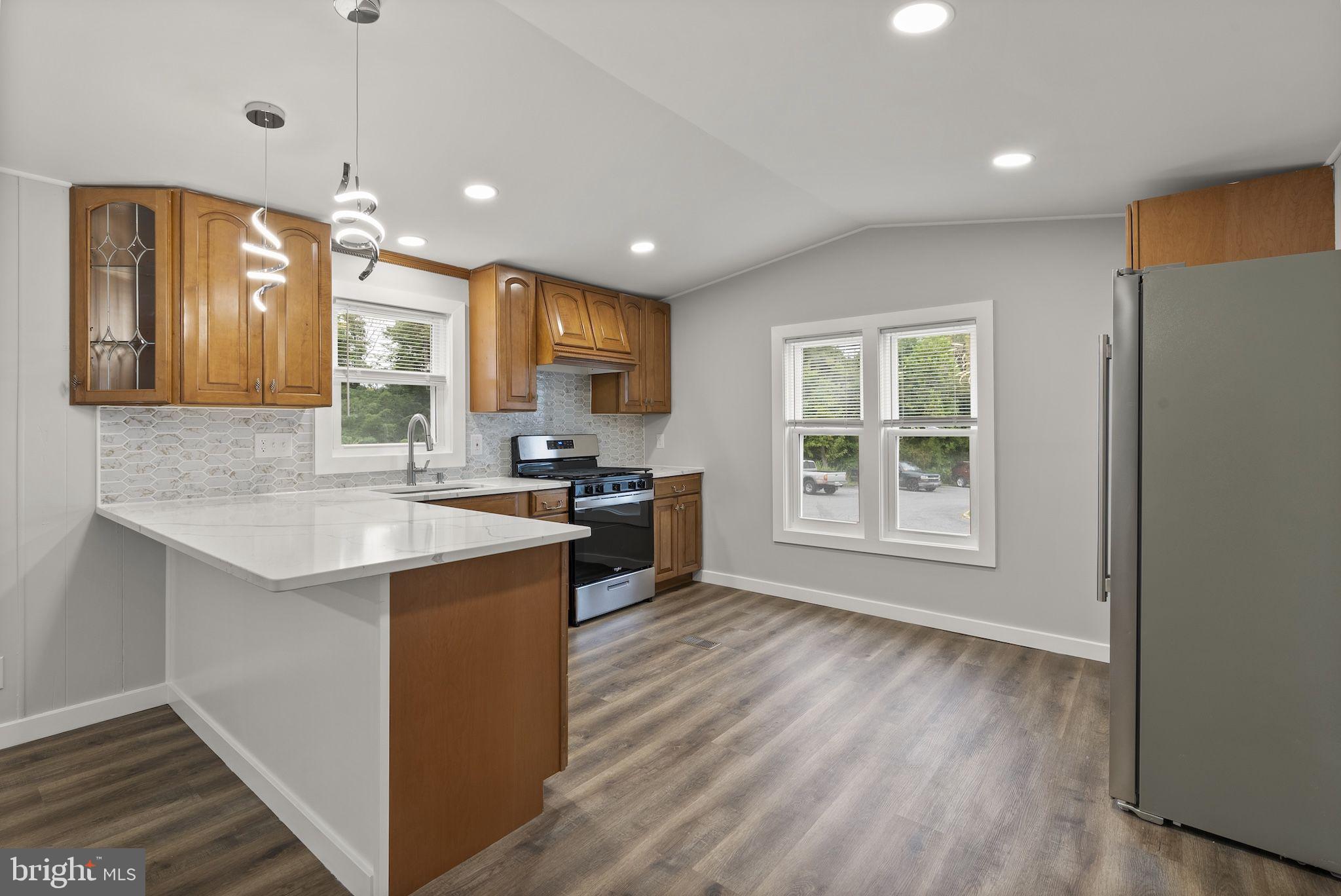 635 Sunset Strip Brooklyn, MD 21225 - Photo 2 of 27 a kitchen with stainless steel appliances granite countertop a sink stove and refrigerator