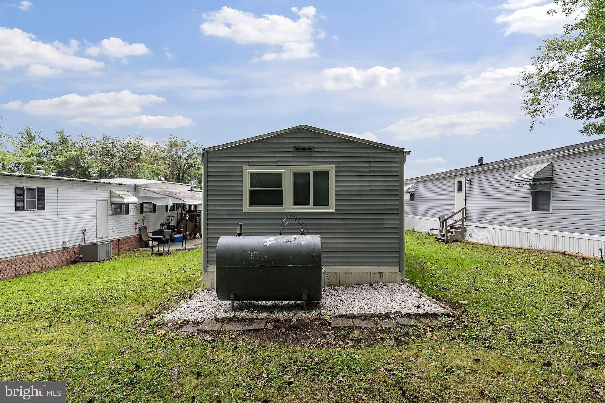 635 Sunset Strip Brooklyn, MD 21225 - Photo 25 of 27 a front view of a house with a yard