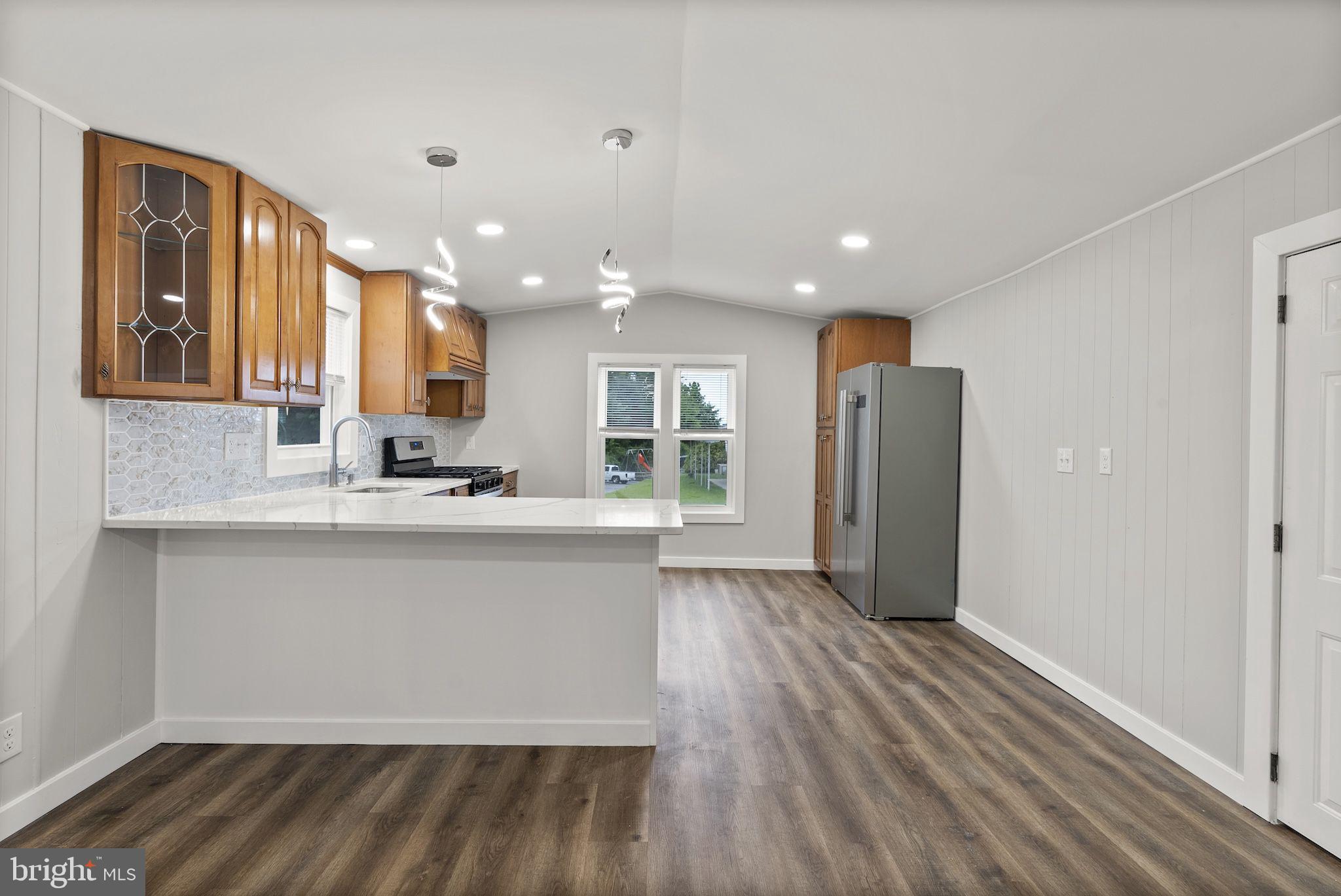 635 Sunset Strip Brooklyn, MD 21225 - Photo 3 of 27 a view of kitchen with stainless steel appliances granite countertop cabinets and wooden floor