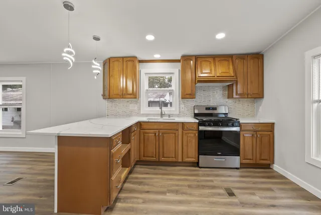 a kitchen with granite countertop a stove and a sink