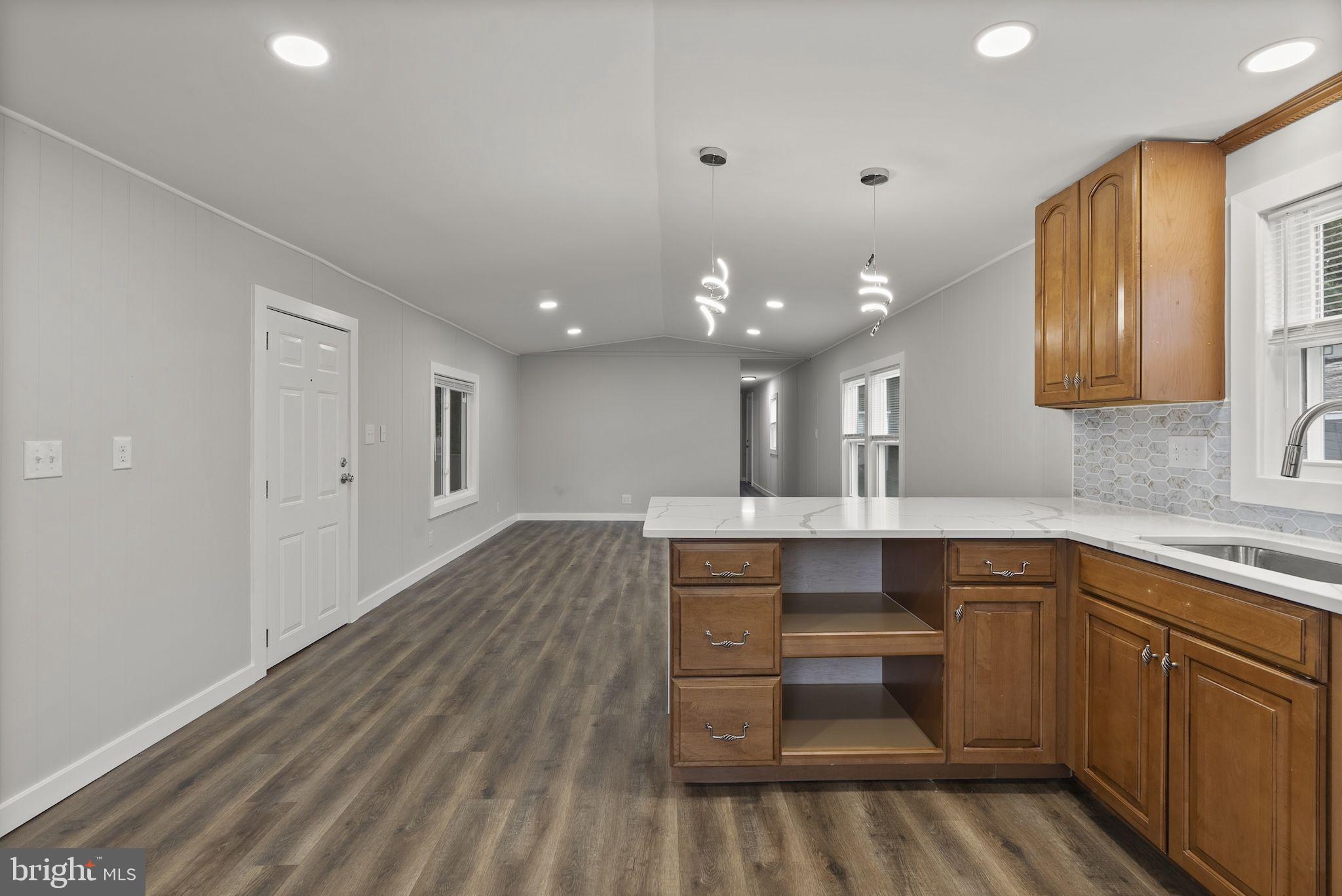 635 Sunset Strip Brooklyn, MD 21225 - Photo 6 of 27 a kitchen with a sink and cabinets
