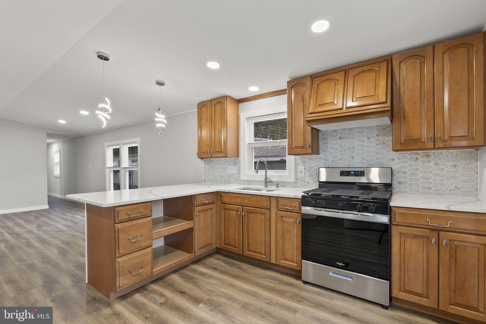 635 Sunset Strip Brooklyn, MD 21225 - Photo 7 of 27 a kitchen with stainless steel appliances granite countertop a stove and a sink