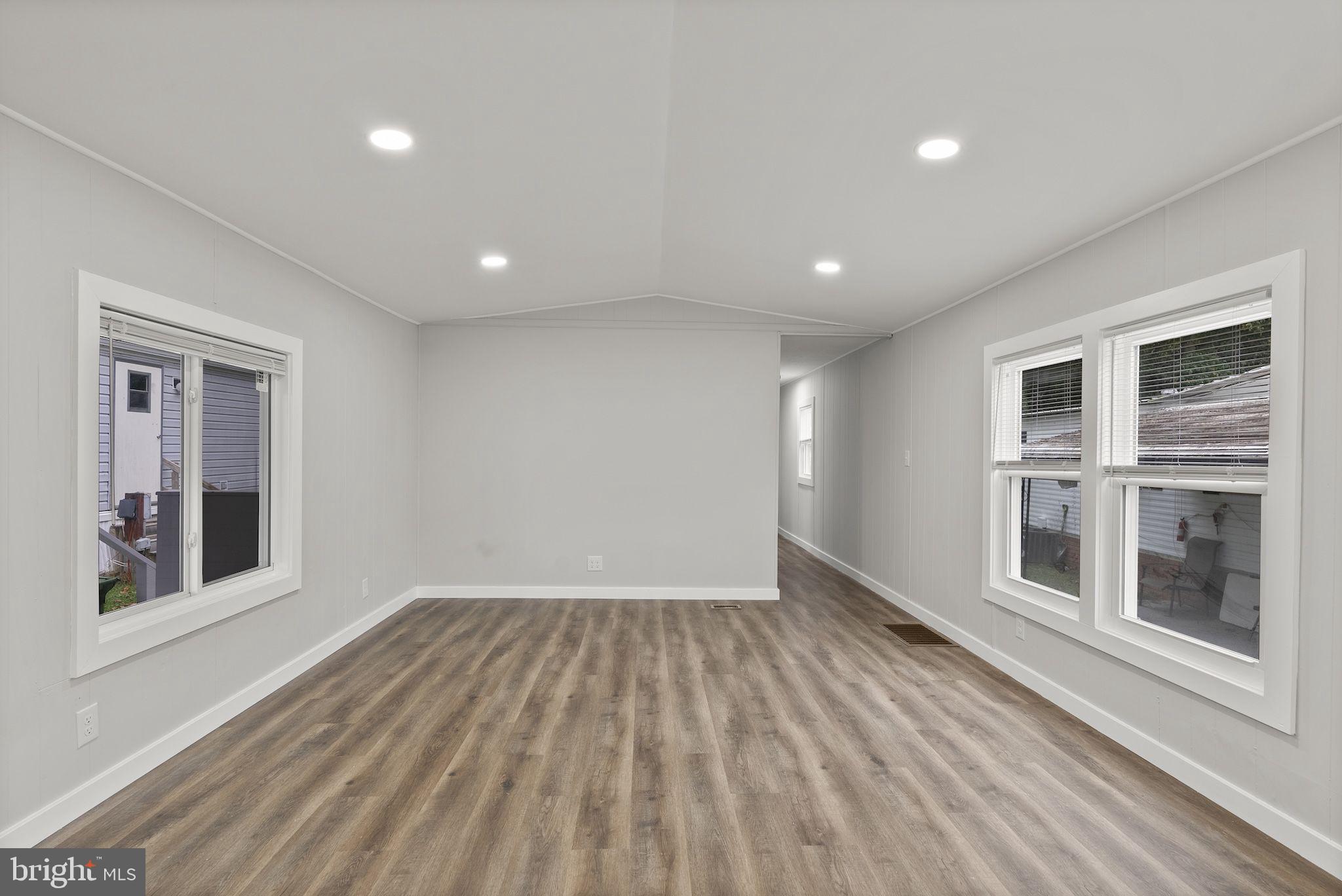 635 Sunset Strip Brooklyn, MD 21225 - Photo 8 of 27 a view of empty room with wooden floor and fan