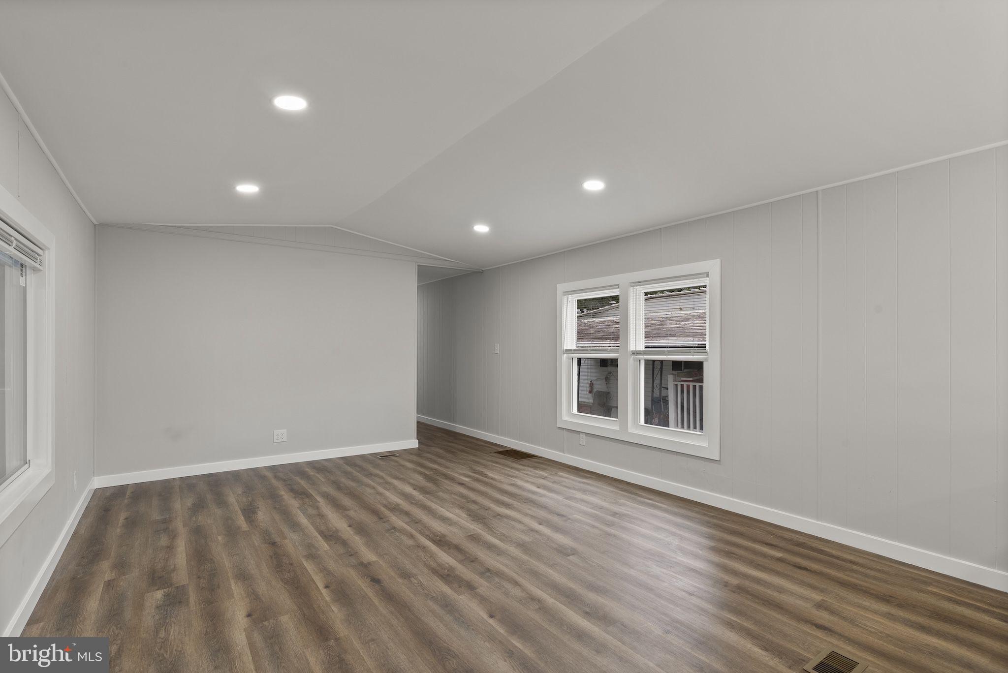 635 Sunset Strip Brooklyn, MD 21225 - Photo 9 of 27 a view of empty room with wooden floor and fan