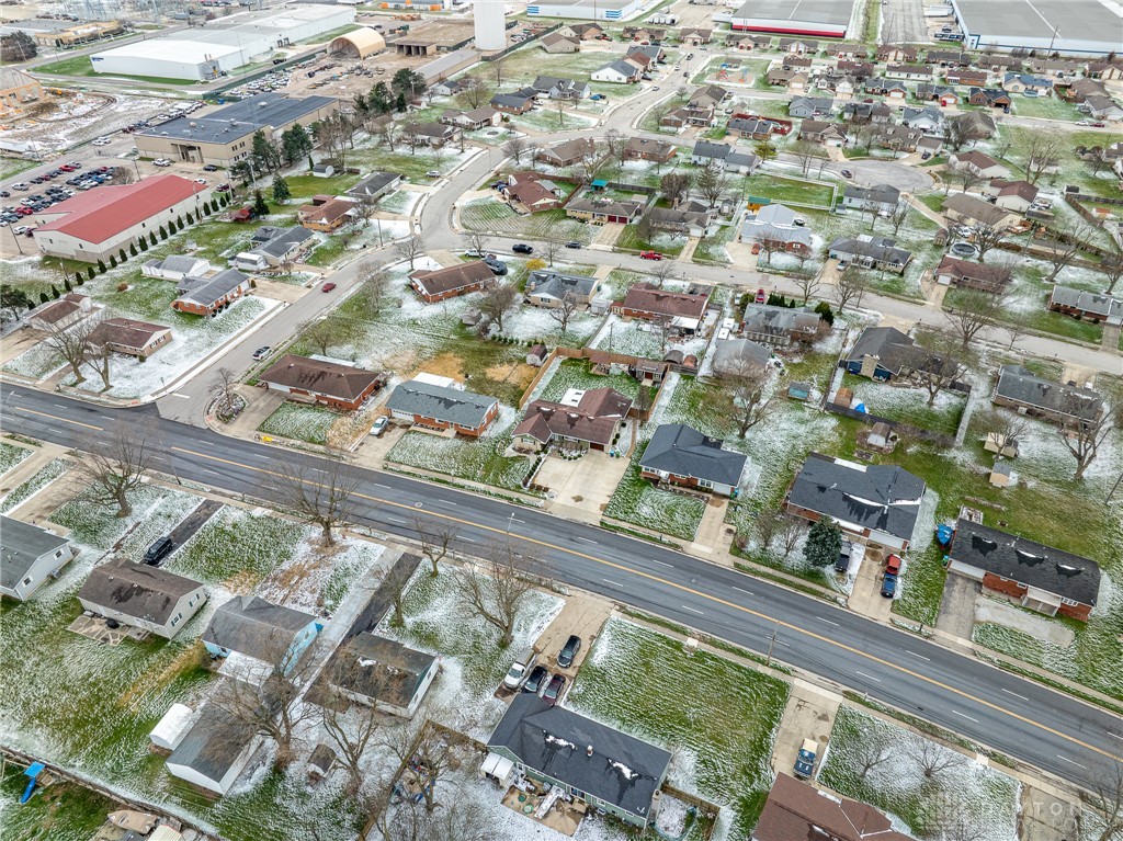 305 South Vandemark Road Sidney, OH 45365 - Photo 2 of 32 An aerial view showcases a residential neighborhood with a mix of homes and surrounding landscape.