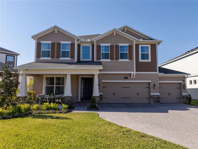 a front view of a house with a yard and garage