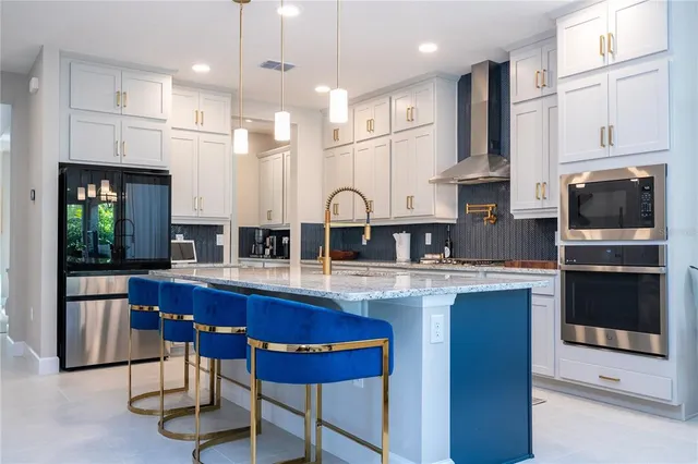 a living room with granite countertop furniture a chandelier a large window and potted plants