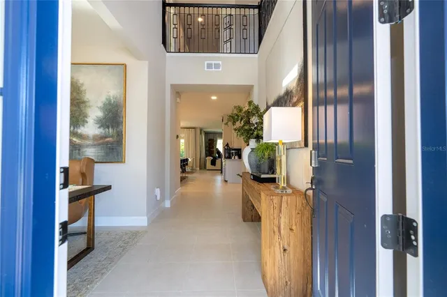 a living room with furniture a table and kitchen view