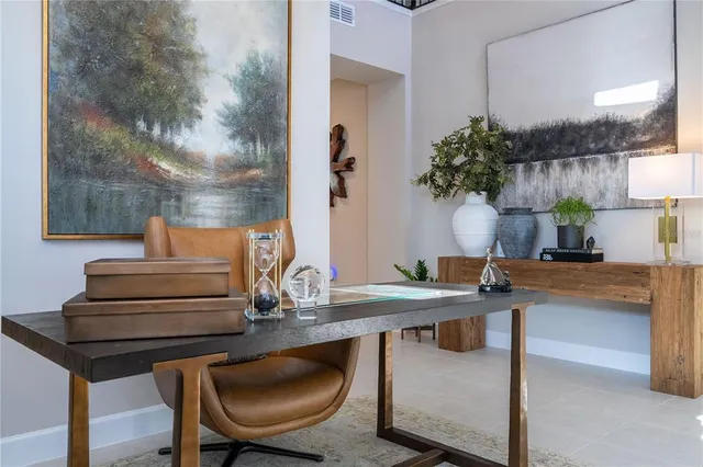 a large white kitchen with granite countertop a sink and cabinets