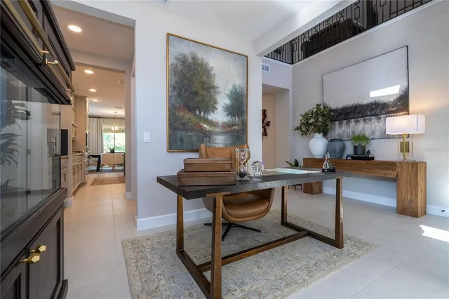 a kitchen with stainless steel appliances granite countertop a stove a sink dishwasher a dining table and chair with wooden floor