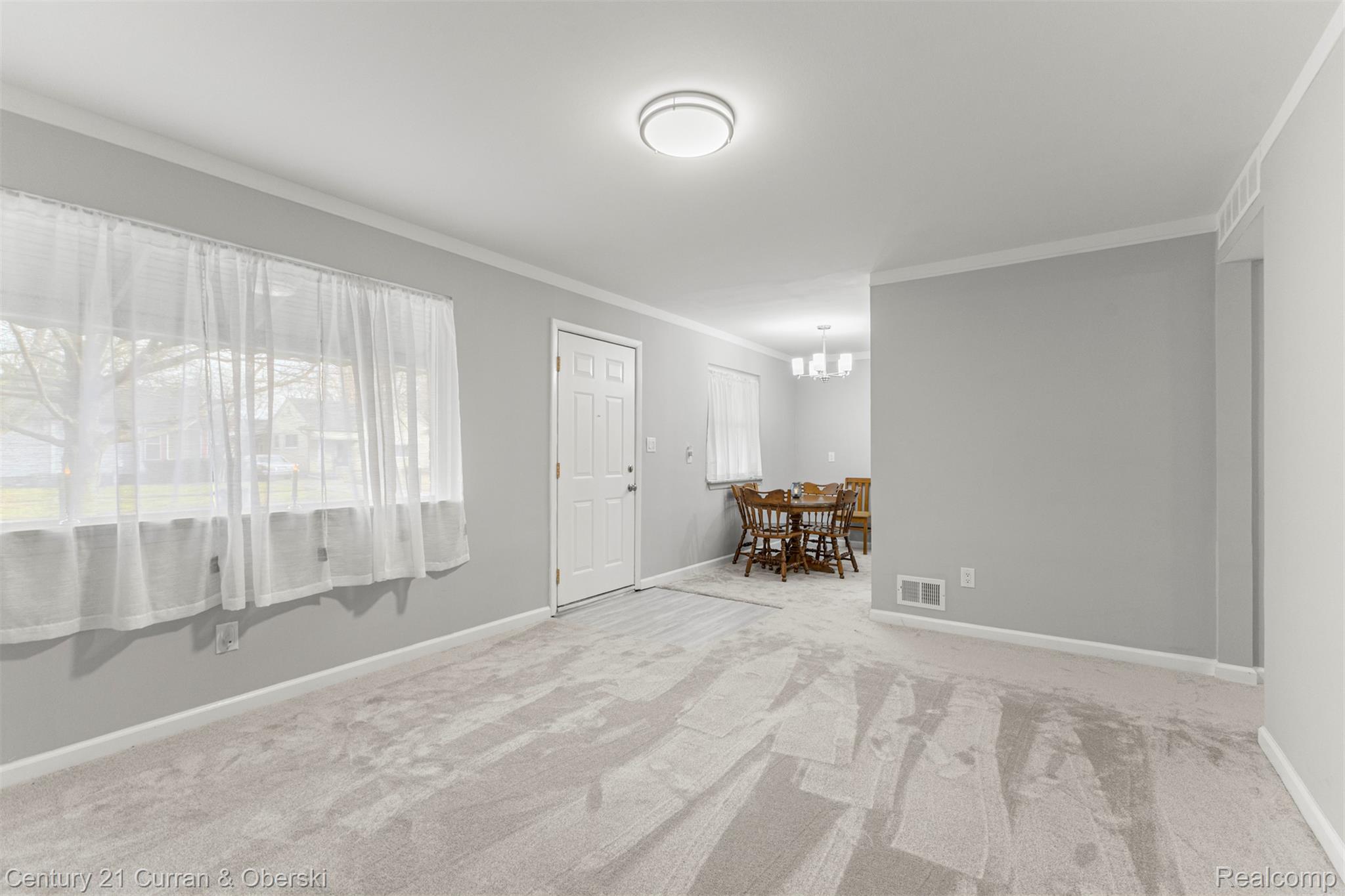 7120 Jackson Street Taylor, MI 48180 - Photo 12 of 24 Empty room with light colored carpet and crown molding