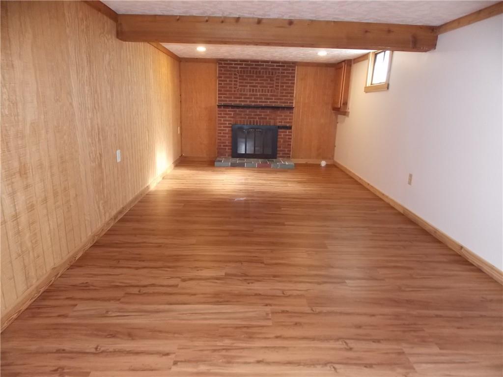 511 Pearl Avenue Mars, PA 16046 - Photo 15 of 21 a view of an empty room with wooden floor fireplace and a window