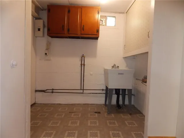 a view of a livingroom with wooden floor and a sink