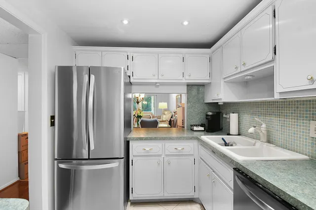 a kitchen with refrigerator cabinets and a sink