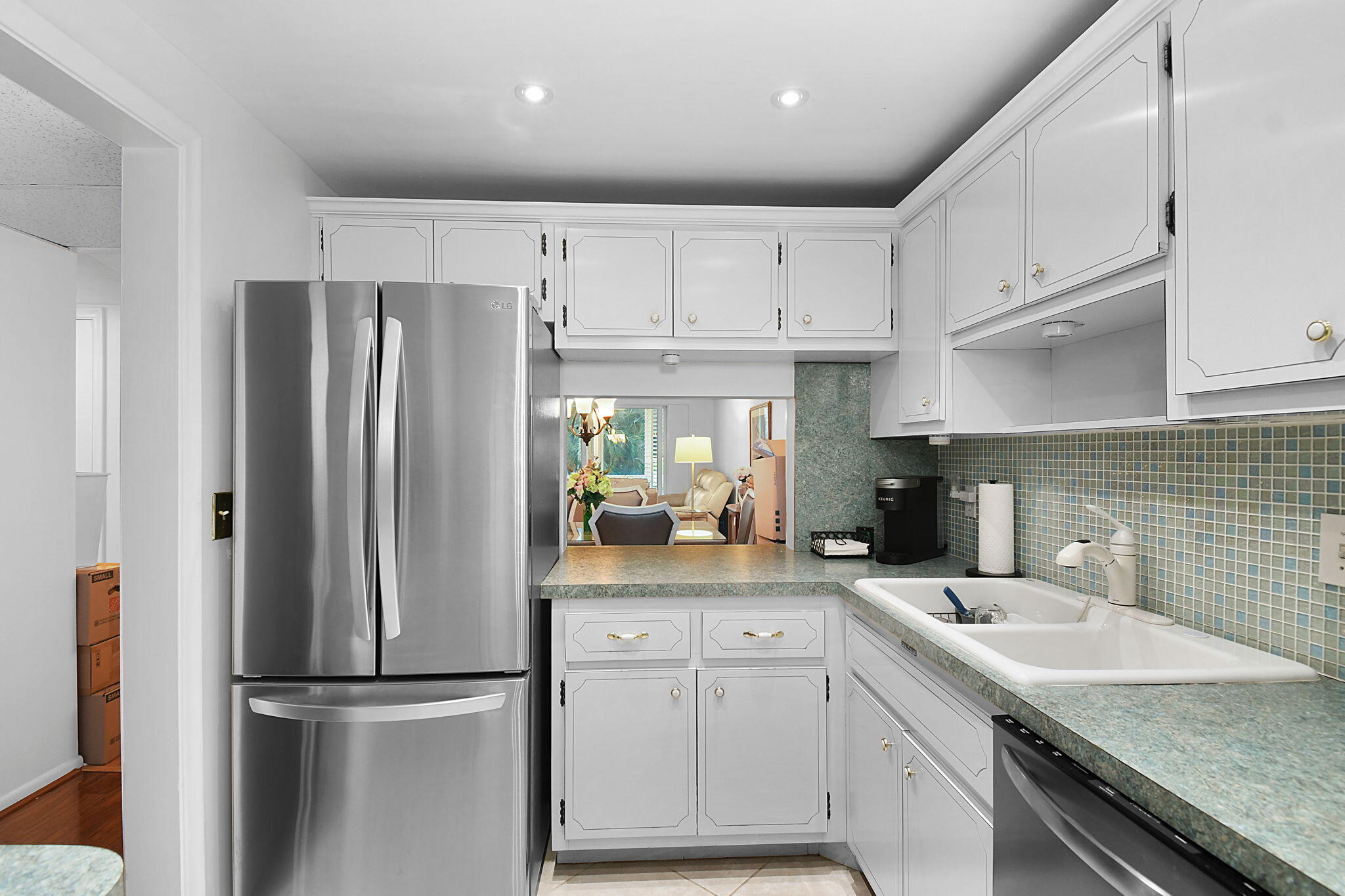 a kitchen with refrigerator cabinets and a sink