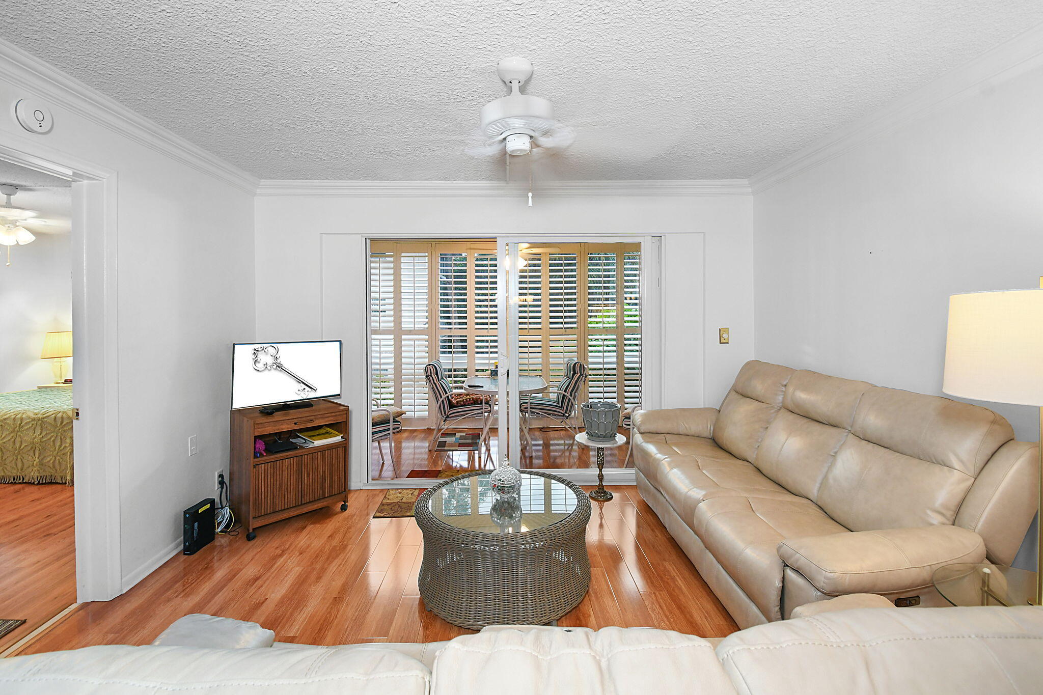 400 Northeast 20th Street, Unit A207 Boca Raton, FL 33431 - Photo 12 of 55 a living room with furniture and a flat screen tv