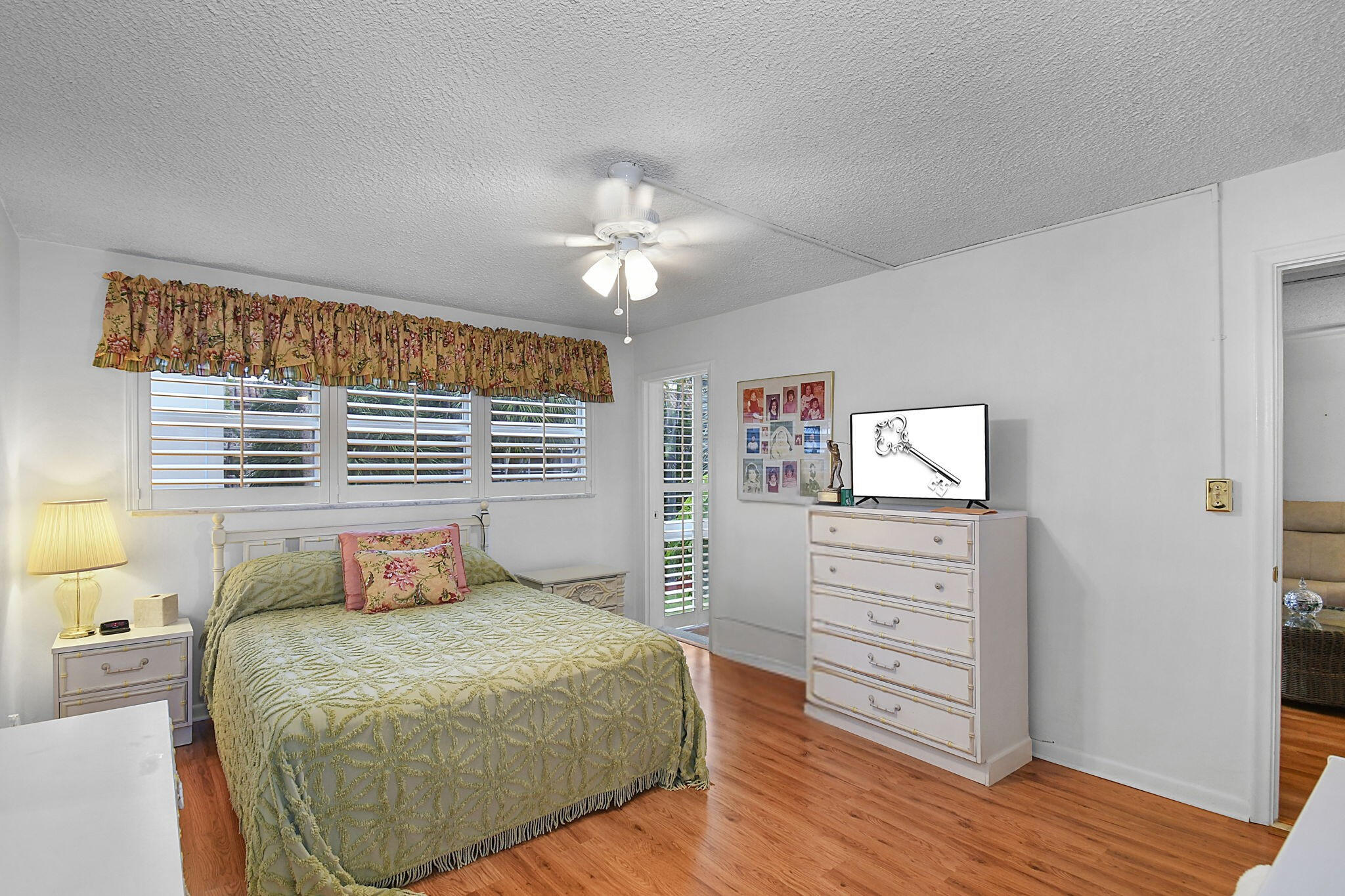 400 Northeast 20th Street, Unit A207 Boca Raton, FL 33431 - Photo 17 of 55 a bedroom with a bed and a window