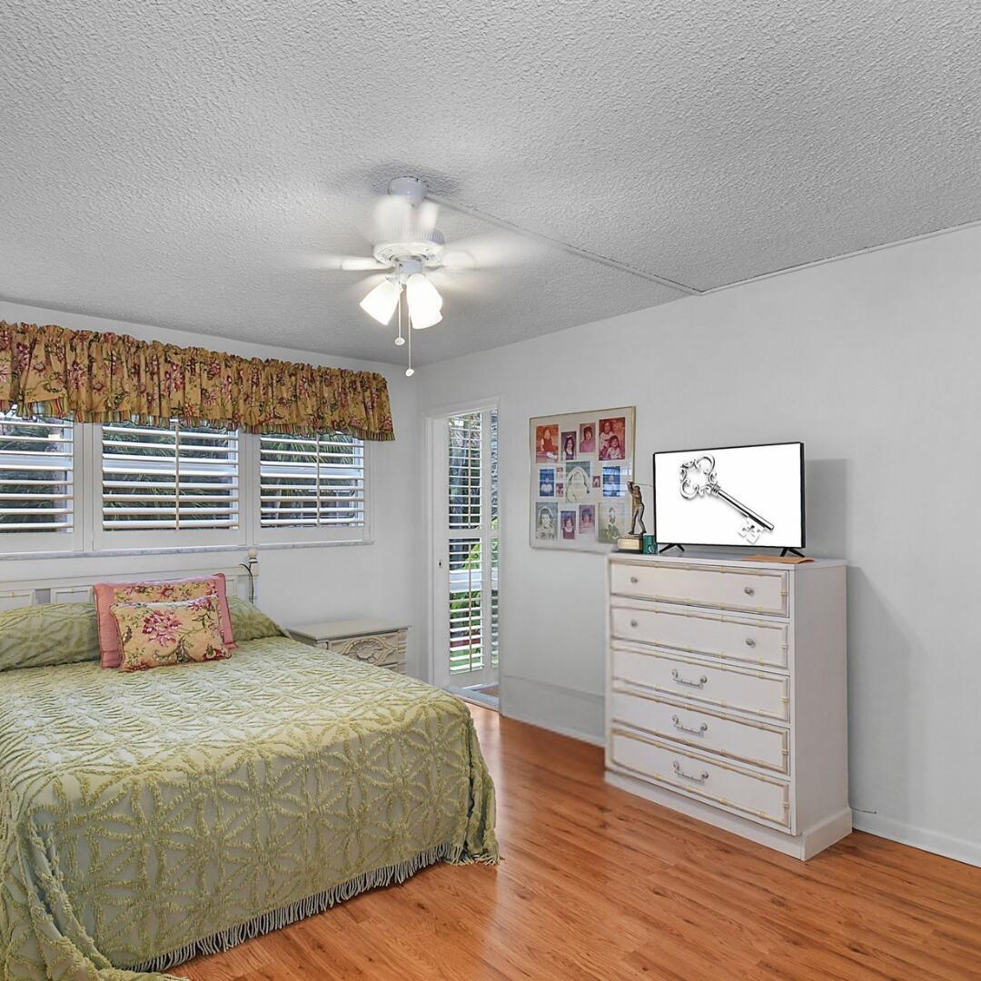 400 Northeast 20th Street, Unit A207 Boca Raton, FL 33431 - Photo 18 of 55 a bedroom with a bed and a dresser