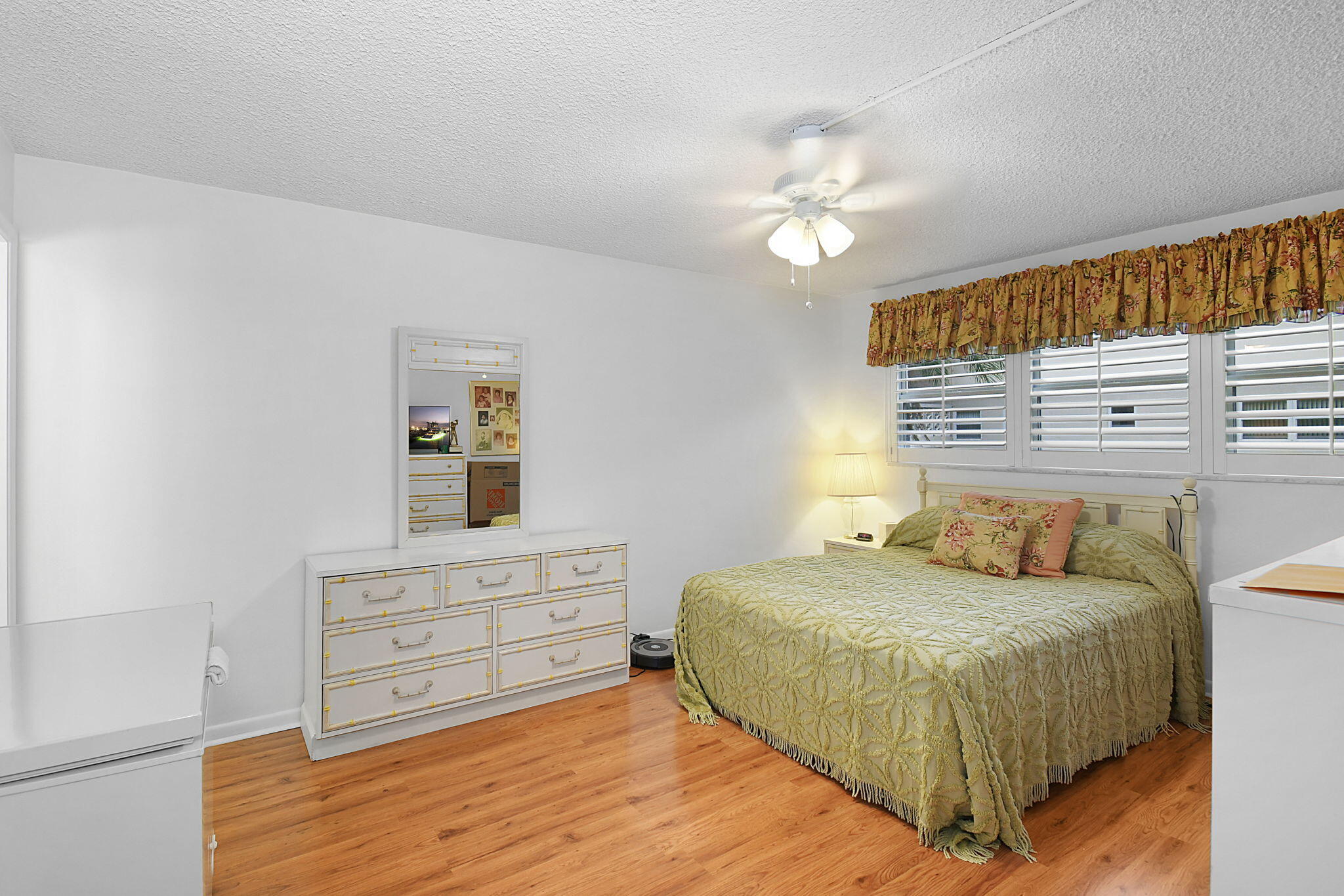 400 Northeast 20th Street, Unit A207 Boca Raton, FL 33431 - Photo 19 of 55 a bedroom with a bed and a chandelier