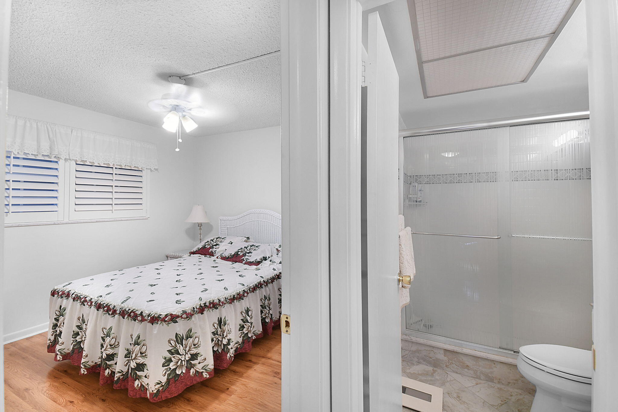 400 Northeast 20th Street, Unit A207 Boca Raton, FL 33431 - Photo 23 of 55 a bedroom with a bed and a table in it