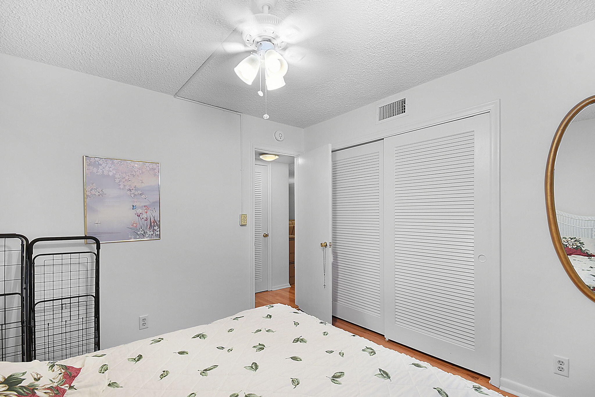 400 Northeast 20th Street, Unit A207 Boca Raton, FL 33431 - Photo 25 of 55 a bedroom with a bed and a chandelier