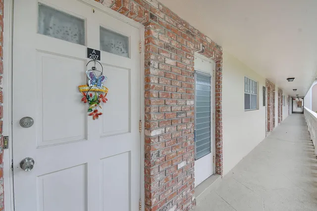 a view of a swimming pool with a patio and a garden