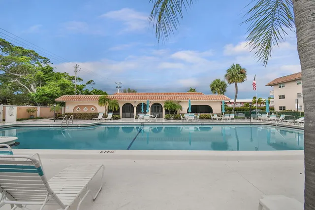 a view of a chairs and table in backyard