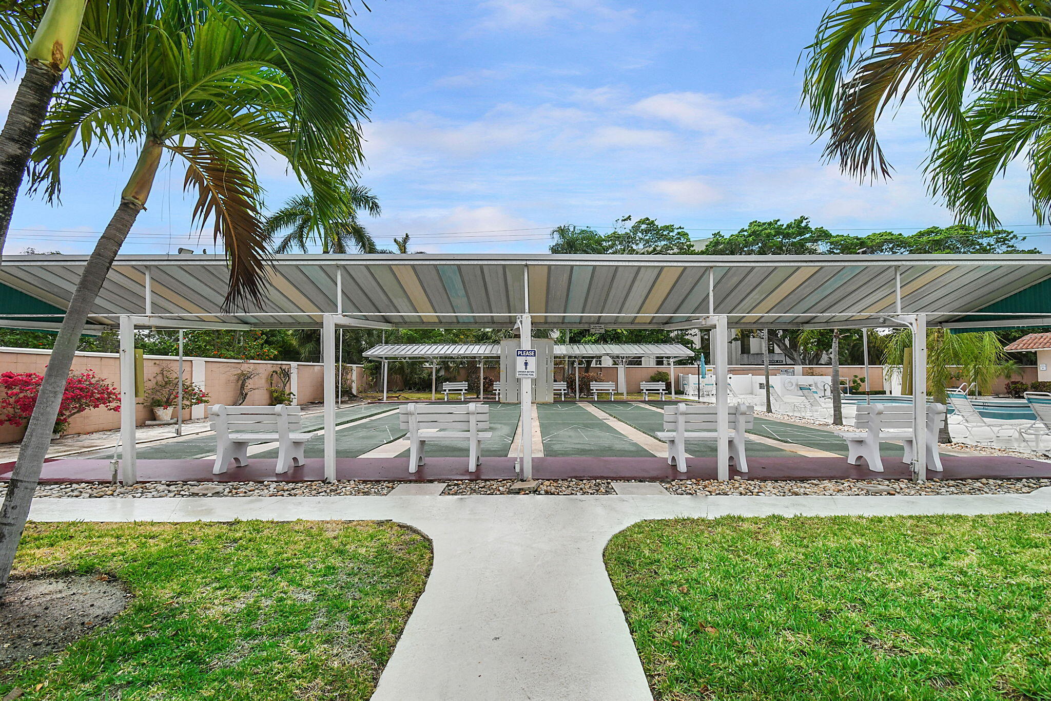 400 Northeast 20th Street, Unit A207 Boca Raton, FL 33431 - Photo 30 of 55 a view of a swimming pool with a patio and a garden