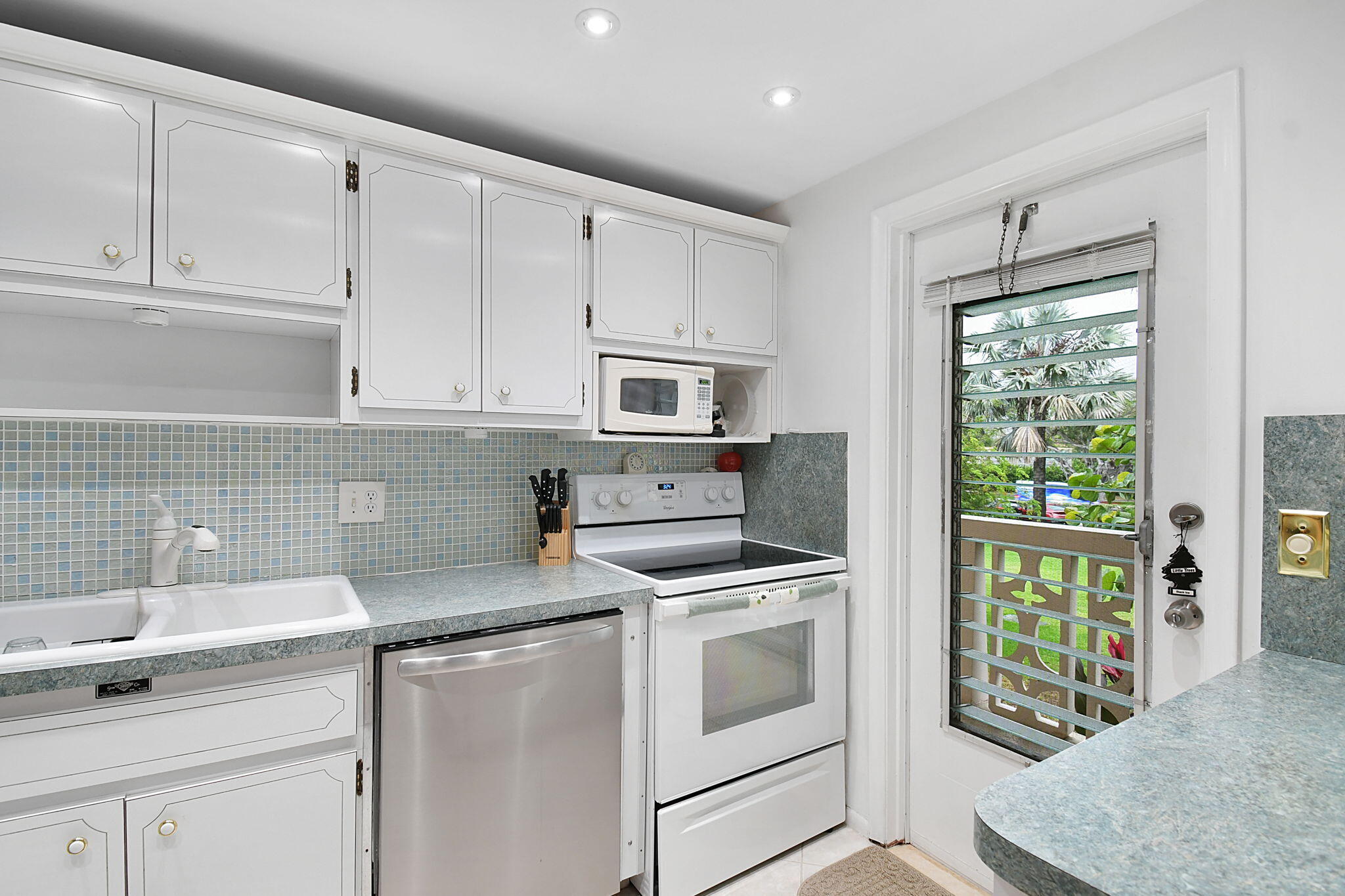 400 Northeast 20th Street, Unit A207 Boca Raton, FL 33431 - Photo 3 of 55 a kitchen with granite countertop a sink stainless steel appliances and cabinets