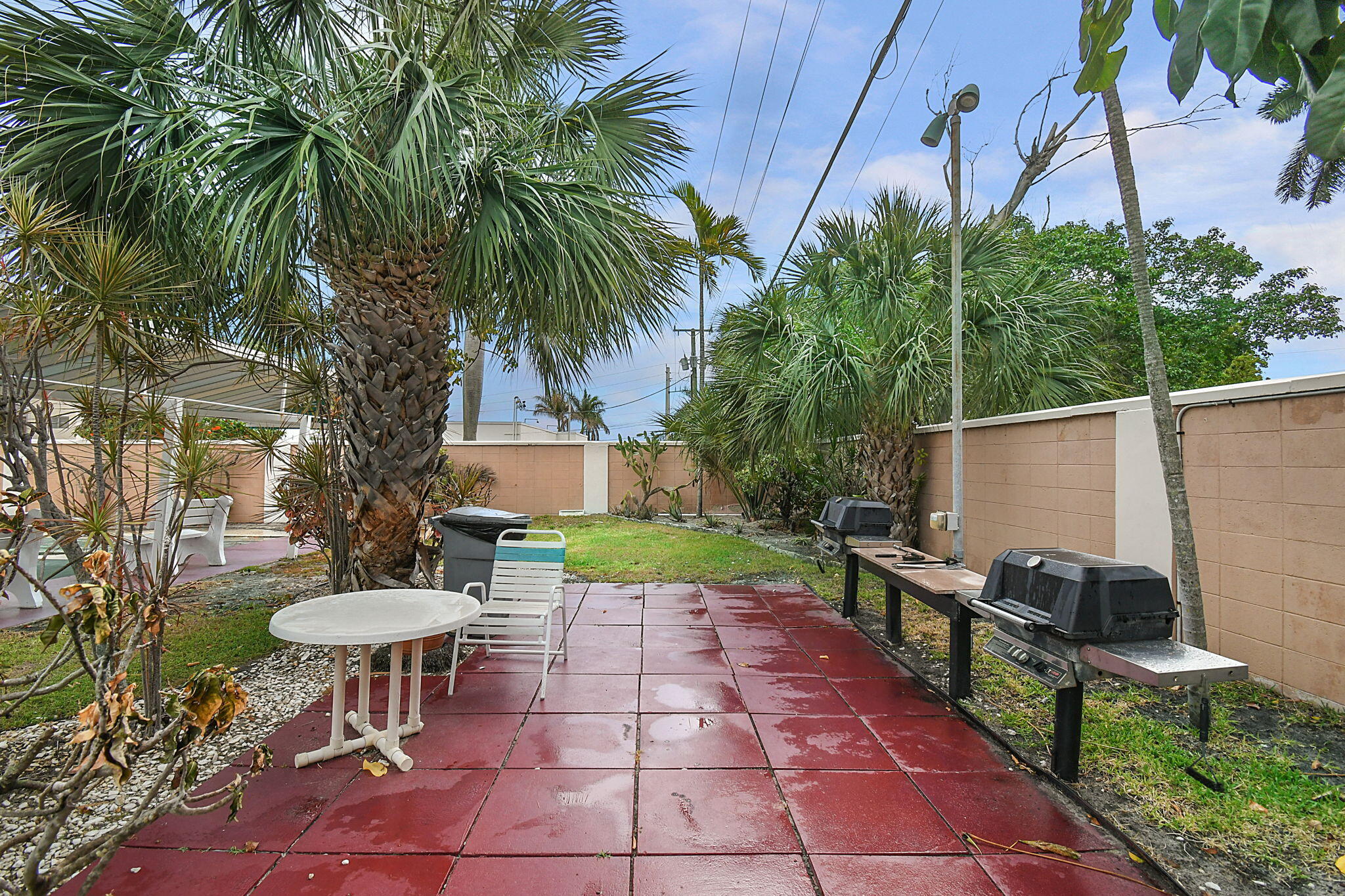 400 Northeast 20th Street, Unit A207 Boca Raton, FL 33431 - Photo 32 of 55 a view of a chairs and table in backyard