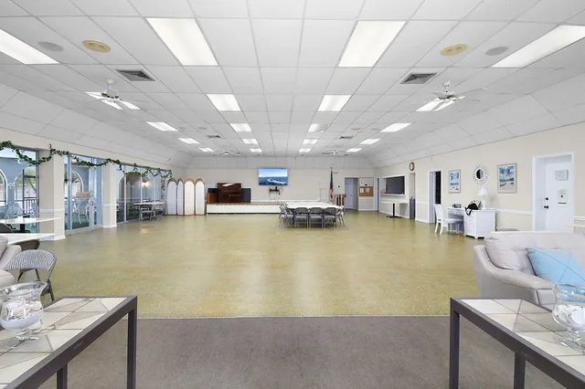a dining room with furniture and a floor to ceiling window