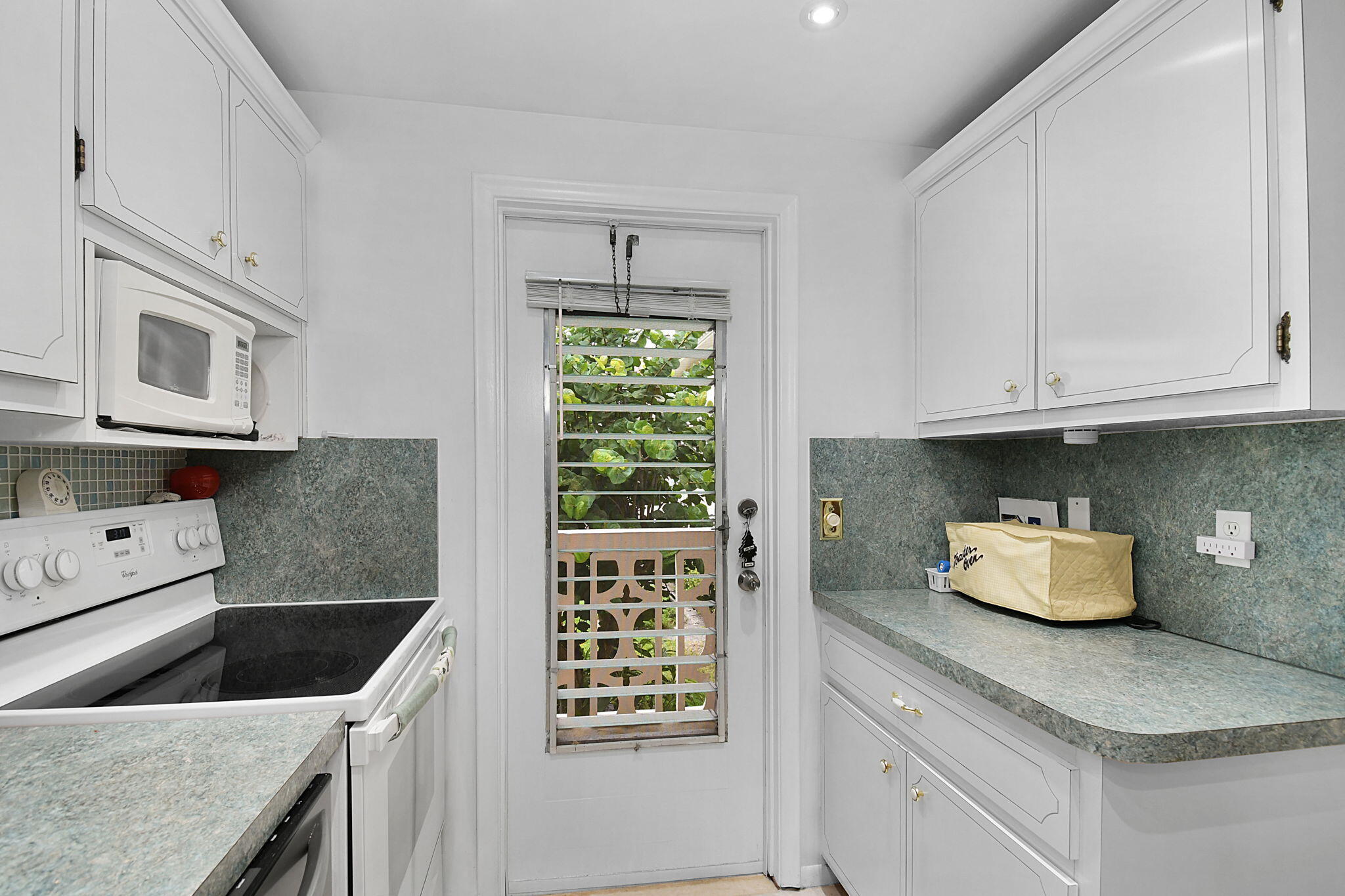 400 Northeast 20th Street, Unit A207 Boca Raton, FL 33431 - Photo 5 of 55 a kitchen with stainless steel appliances granite countertop a sink stove and cabinets