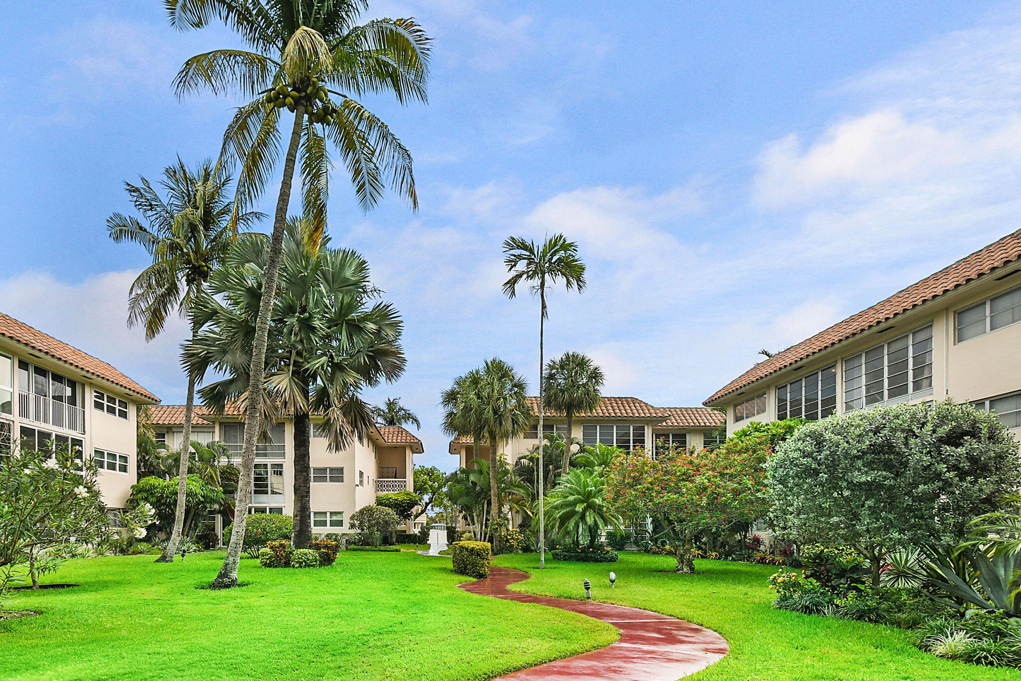 400 Northeast 20th Street, Unit A207 Boca Raton, FL 33431 - Photo 53 of 55 a front view of multi story residential apartment building with yard and green space
