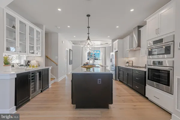 a large kitchen with stainless steel appliances granite countertop a stove and a refrigerator